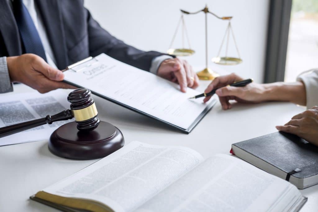 businesswoman and Male lawyers working and discussion having at law firm in office