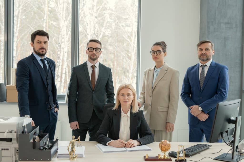 Chef of law firm surrounded by lawyers