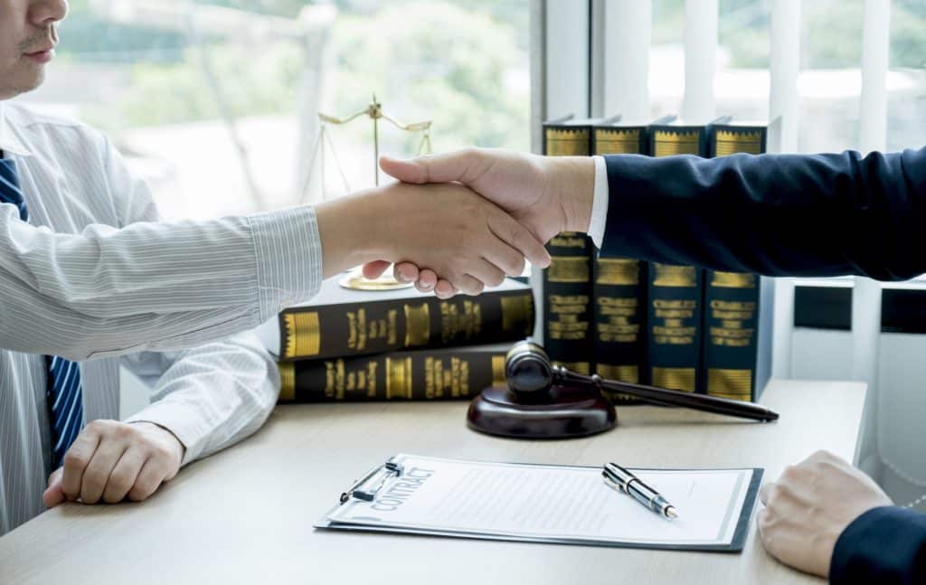 Handshake after Lawyer providing legal consult business dispute service to the man at the office